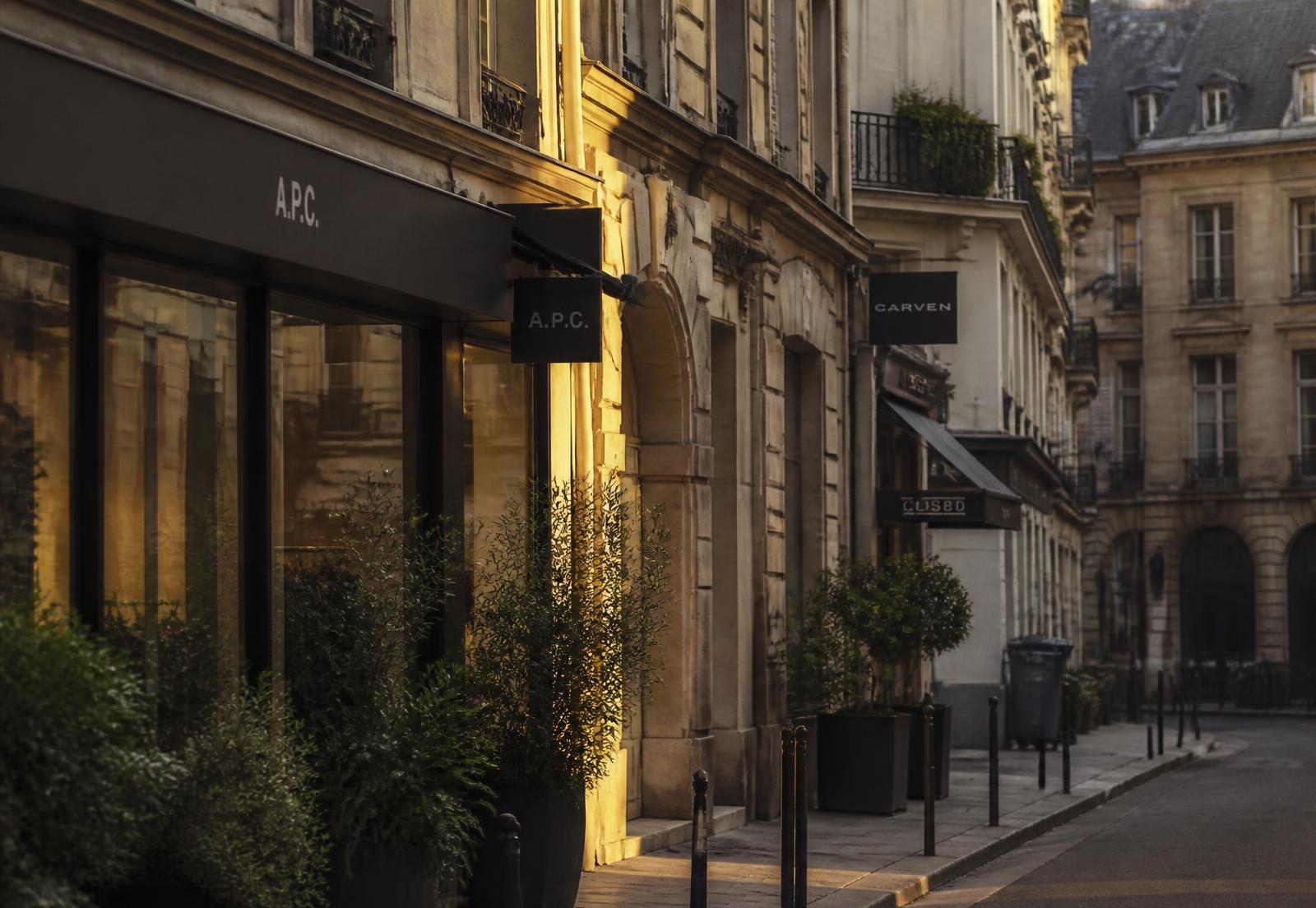 Early morning light on an independent retail street of stone-fronted shopfronts